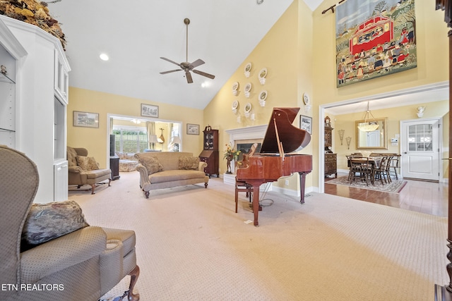 living room with ceiling fan, high vaulted ceiling, and hardwood / wood-style flooring