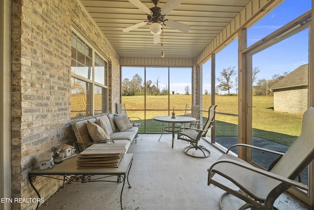 sunroom / solarium featuring ceiling fan