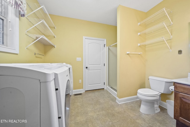 laundry room featuring washer and dryer and light tile patterned floors