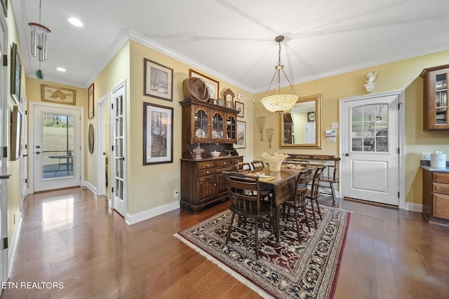 dining room featuring crown molding and dark wood-type flooring