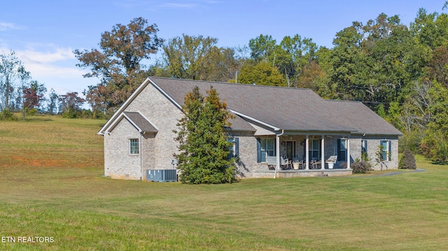 view of front facade with central air condition unit, a front lawn, and covered porch