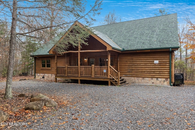 log cabin featuring covered porch