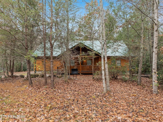 back of house featuring a wooden deck