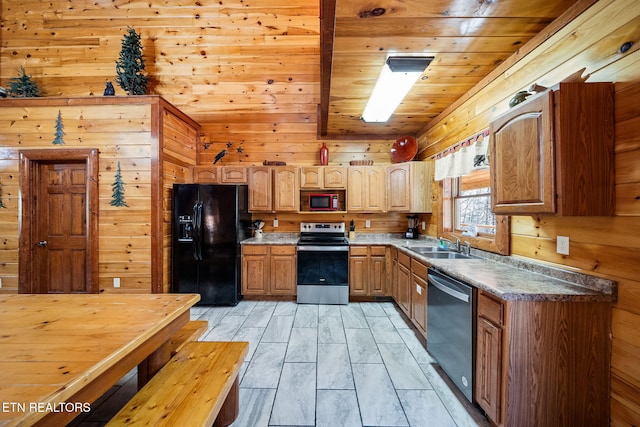 kitchen featuring wood ceiling, wooden walls, sink, black appliances, and light hardwood / wood-style flooring