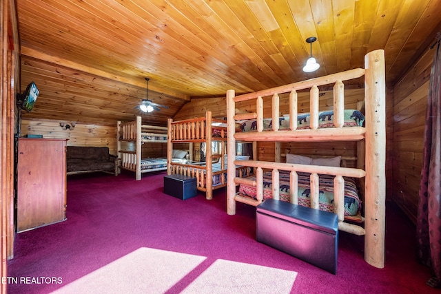 carpeted bedroom with wooden walls, vaulted ceiling, and wooden ceiling