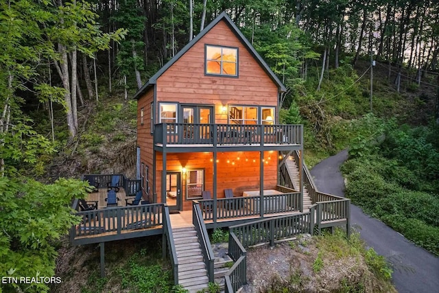 back of property featuring a wooden deck