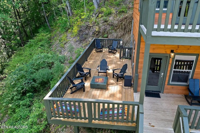 deck featuring an outdoor fire pit