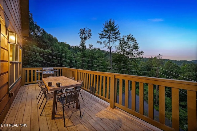 deck at dusk with area for grilling