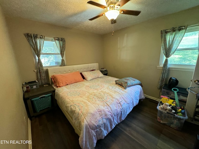 1005 Hollywood Dr, Middlesboro, KY 40965 - bedroom with dark wood-type flooring, ceiling fan, and a textured ceiling