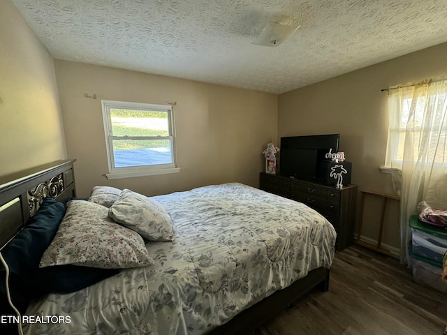 1005 Hollywood Dr, Middlesboro, KY 40965 - bedroom with a textured ceiling and dark hardwood / wood-style flooring