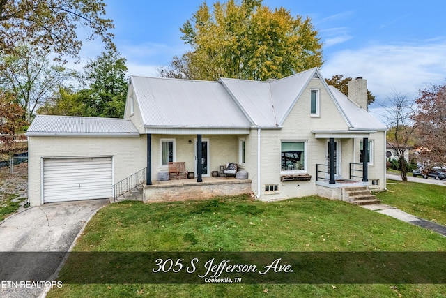 view of front of home with a front yard, a garage, and covered porch