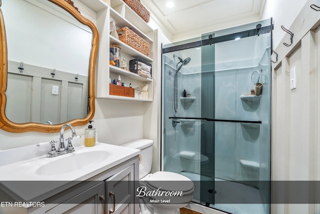 bathroom with vanity, toilet, and a shower with door