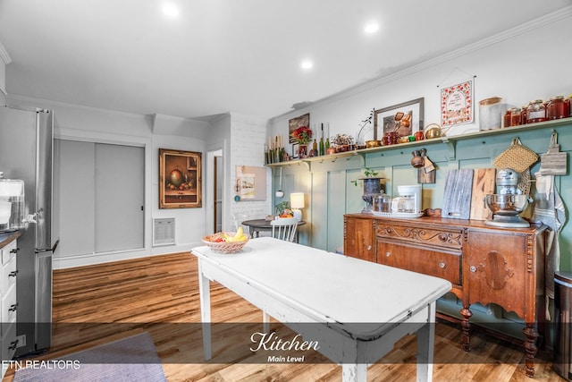 interior space with crown molding and hardwood / wood-style flooring