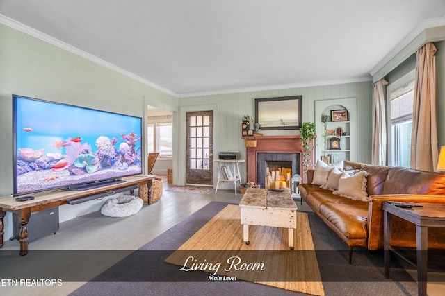 living room featuring built in features, dark hardwood / wood-style floors, and ornamental molding