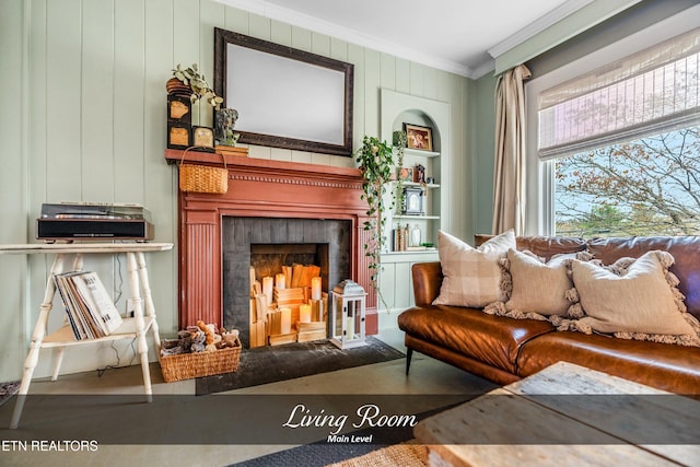 living area with hardwood / wood-style floors and ornamental molding