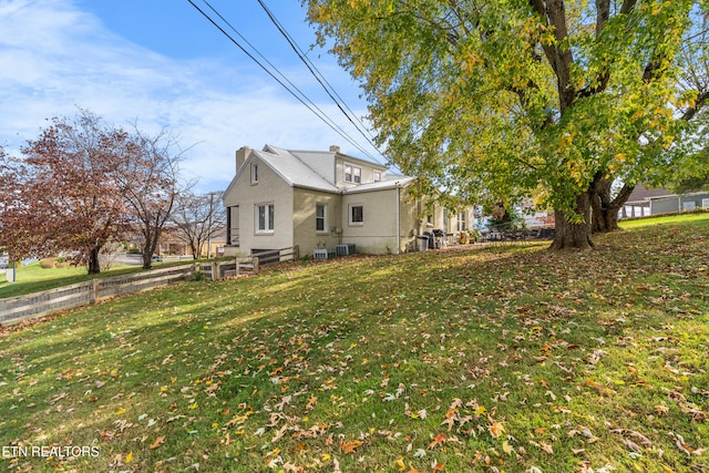 view of home's exterior with a lawn