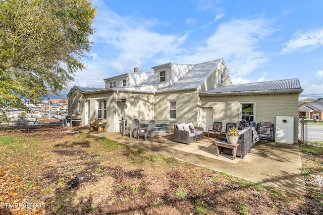 back of property with outdoor lounge area and a patio area