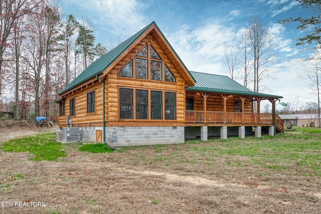 rear view of house featuring central AC