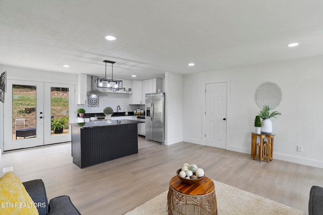 living room featuring french doors and light wood-type flooring