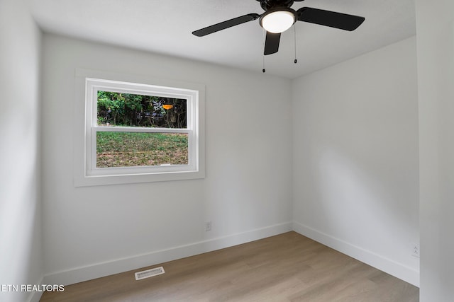 spare room featuring light wood-type flooring and ceiling fan