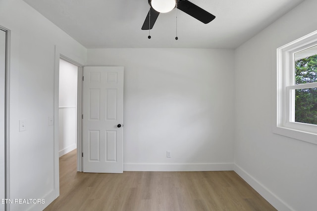 unfurnished room with ceiling fan and light wood-type flooring