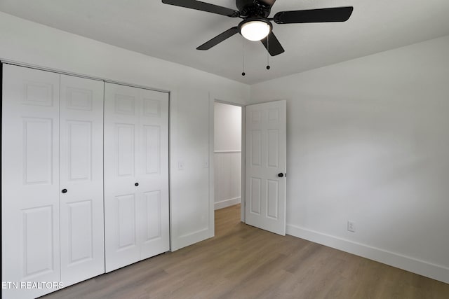 unfurnished bedroom with a closet, light hardwood / wood-style floors, and ceiling fan