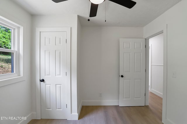 unfurnished bedroom with a textured ceiling, light hardwood / wood-style flooring, and ceiling fan