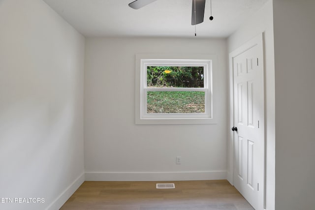 empty room featuring light wood-type flooring and ceiling fan