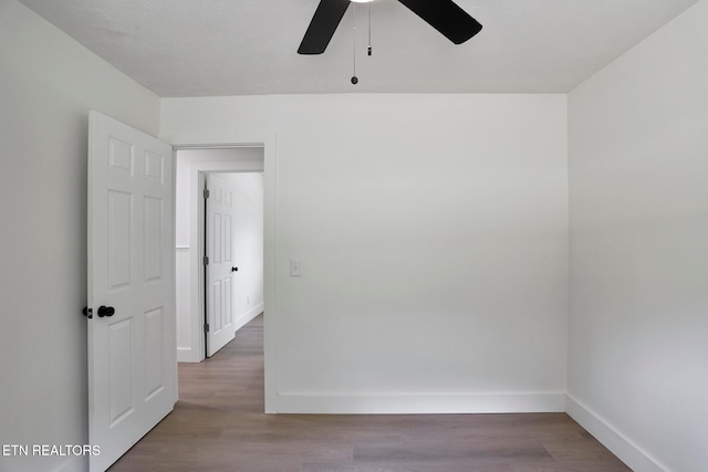 spare room featuring hardwood / wood-style floors and ceiling fan