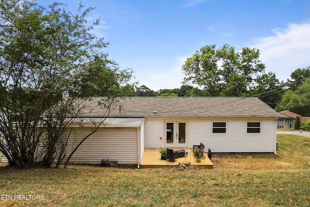 back of house with a lawn, a wooden deck, and french doors