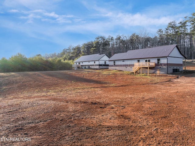 view of yard featuring central AC and a deck