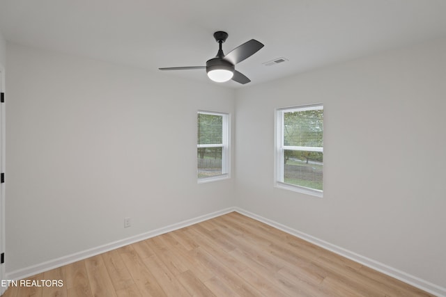 empty room featuring ceiling fan and light hardwood / wood-style floors