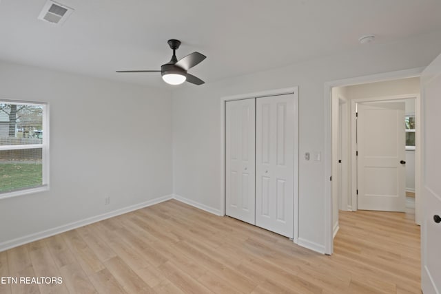 unfurnished bedroom with a closet, ceiling fan, and light hardwood / wood-style flooring