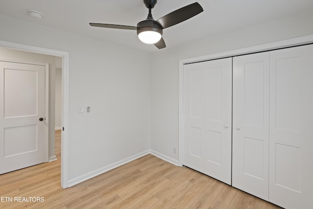 unfurnished bedroom with ceiling fan, a closet, and light hardwood / wood-style floors