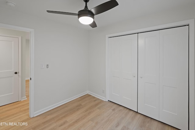 unfurnished bedroom with ceiling fan, a closet, and light hardwood / wood-style floors