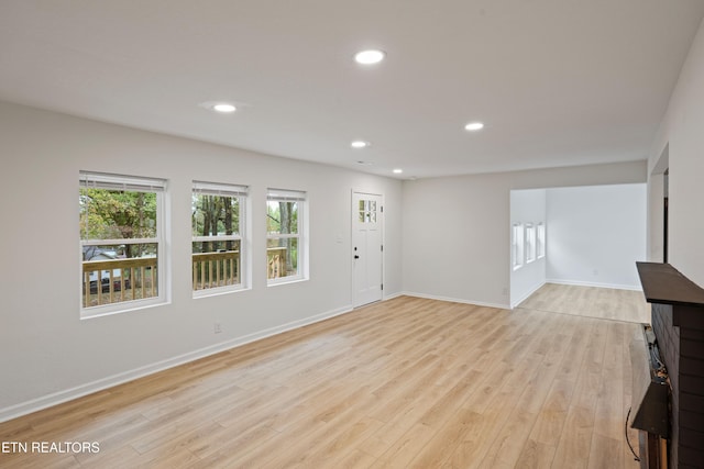 unfurnished living room featuring light hardwood / wood-style flooring