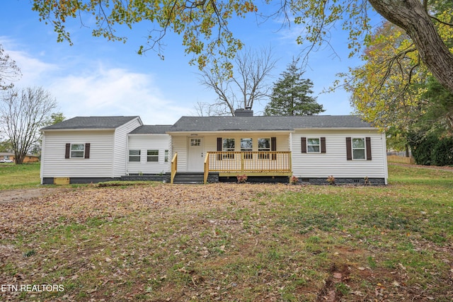 ranch-style house with a front lawn and a deck