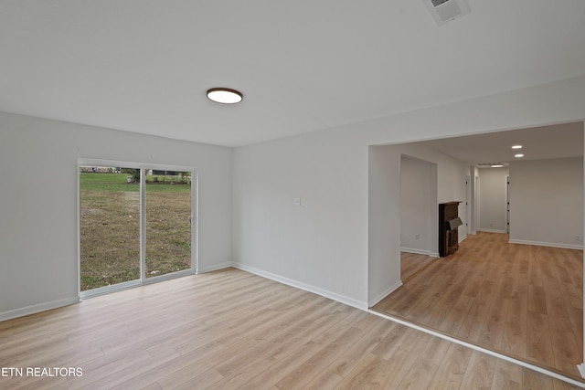 unfurnished room with light hardwood / wood-style floors