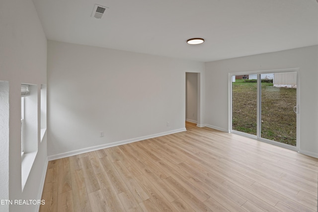 spare room featuring light hardwood / wood-style floors