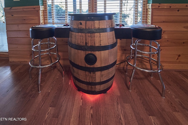 details with hardwood / wood-style floors and wooden walls