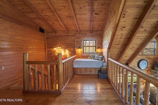 unfurnished bedroom featuring multiple windows, wooden ceiling, and wood walls