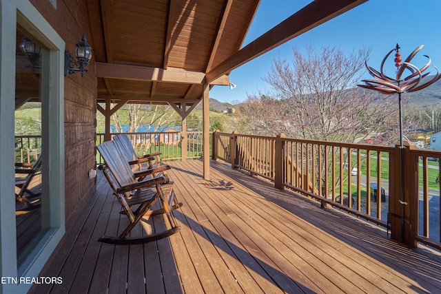 wooden deck with a mountain view