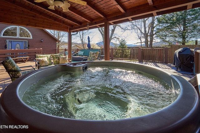 view of pool with a grill and a hot tub