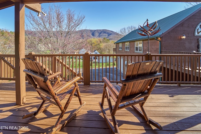 wooden deck featuring a mountain view