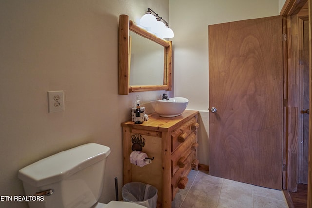 bathroom with tile patterned floors, vanity, and toilet