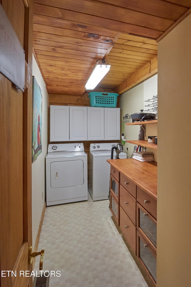 washroom featuring independent washer and dryer, cabinets, and wooden ceiling