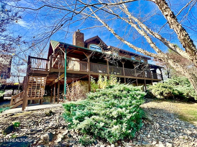 back of property featuring a wooden deck