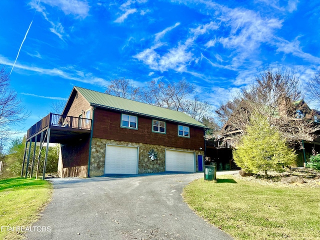 view of home's exterior with a lawn, a garage, and a wooden deck