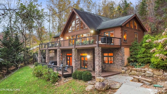 back of property with a balcony and a wooden deck