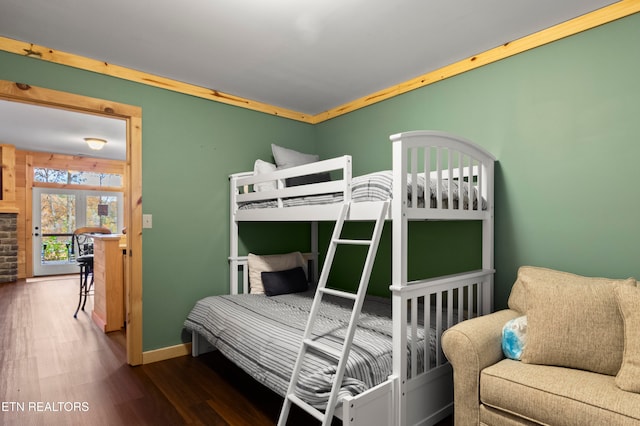 bedroom featuring dark wood-type flooring and crown molding